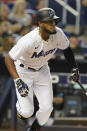 Miami Marlins' Bryan De La Cruz watches his hit during the first inning of a baseball game against the Washington Nationals, Tuesday, Sept. 21, 2021, in Miami. (AP Photo/Marta Lavandier)