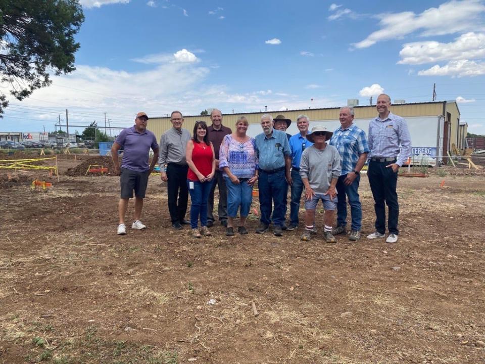 Organizers, volunteers and local officials gather to celebrate the start of construction on Victory Village. The site will eventually feature 10 small homes that will provide transitional housing to community members experiencing homelessness.