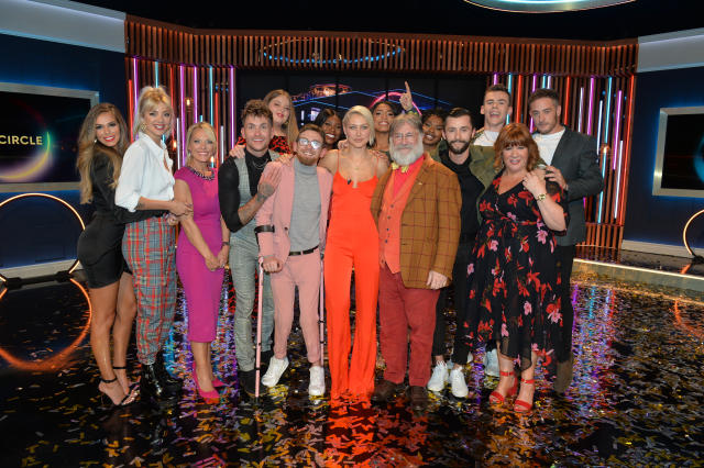 Winner Paddy Smyth (in pink), host Emma Willis (cente) and Viewer's Champion Tim Wilson celebrate with the other finalists and blocked contestants after the final of the second series of Channel 4's The Circle in Salford, Manchester. (Photo by Peter Powell/PA Images via Getty Images)