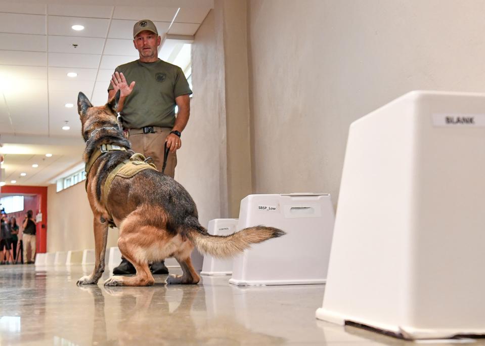 Aug 4, 2022; Tuscaloosa, AL, USA; The Department of Homeland Security Science and Technology Directorate’s  Regional Explosives Detection Dog Initiative demonstrates what the canines and their handlers are learning in an event hosted by the University of Alabama Police Department at Sewell-Thomas Stadium Thursday, Aug. 4, 2022. Birmingham officer Metz Davis gives his dog Mikey a command after the K-9 successfully completed a scent recognition course. Mandatory Credit: Gary Cosby Jr.-Tuscaloosa News