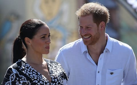 The Duke and Duchess of Sussex prepare to make their speeches - Credit: Getty