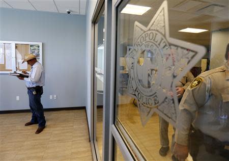 Ammon Bundy, son of rancher Cliven Bundy, fills out a criminal complaint against the federal Bureau of Land Management (BLM) at the Las Vegas Metropolitan Police Department in Las Vegas, Nevada May 2, 2014. REUTERS/Mike Blake