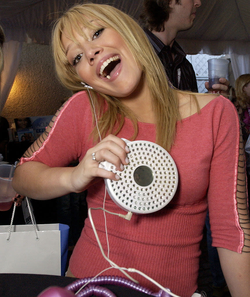 Hilary with headphones attached to a portable CD player