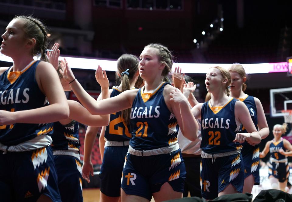 Members of the Regina Catholic girls basketball team take the court prior to their Class 2A quarterfinal game against Sibley-Ocheyedan at Wells Fargo Arena in Des Moines on Tuesday.