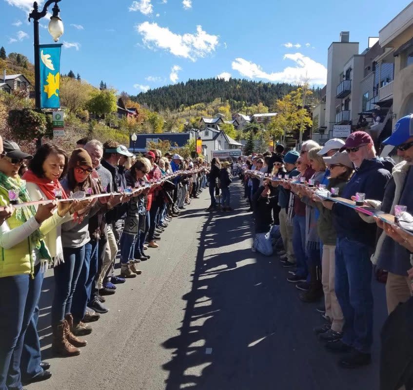 Participants line up on Park City's Main Street with skis and shots in hand.<p>Park City Sunrise Rotary Club</p>