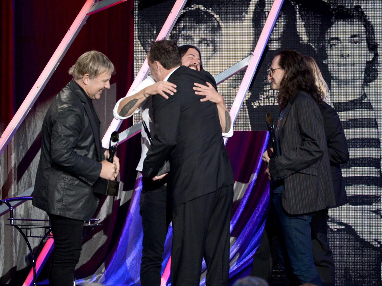 Dave Grohl Hugs Neil Peart at the Rock And Roll Hall Of Fame