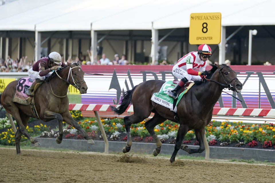 Jose Ortiz, right, atop Early Voting, heads to the finish line with Joel Rosario, atop Epicenter, at his tail before winning the 147th running of the Preakness Stakes horse race at Pimlico Race Course, Saturday, May 21, 2022, in Baltimore. (AP Photo/Julio Cortez)