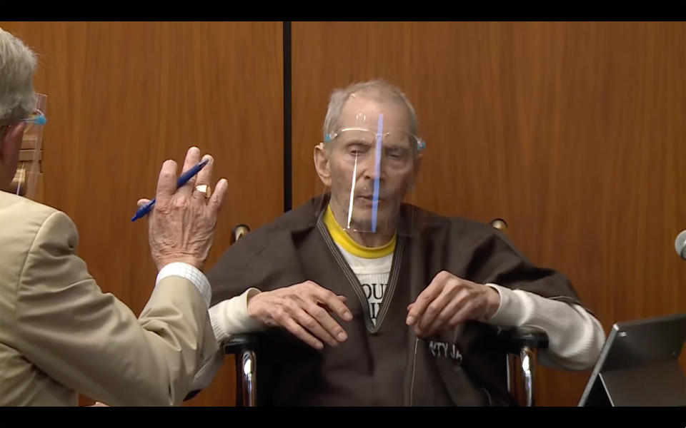 In this still image taken from the Law & Crime Network court video, defense attorney Dick Deguerin holds his hand up to stop his client real estate heir Robert Durst, from talking during his murder trial on Monday, Aug. 9, 2021, in Los Angeles County Superior Court in Inglewood, Calif. (Law & Crime Network via AP, Pool)