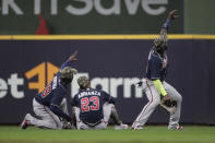 Atlanta Braves' Marcell Ozuna, right, poses with Ehire Adrianza (23) and Guillermo Heredia (38) after the the team's baseball game against the Milwaukee Brewers on Saturday, May 15, 2021, in Milwaukee. (AP Photo/Aaron Gash)