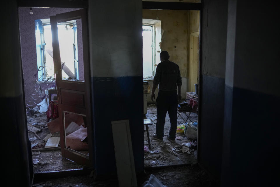 A local resident gathers up belongings from his heavily damaged house after a Russian strike in Pokrovsk, eastern Ukraine, Wednesday, May 25, 2022. Two rockets struck the eastern Ukrainian town of Pokrovsk, in the Donetsk region early Wednesday morning, causing at least four injuries. (AP Photo/Francisco Seco)