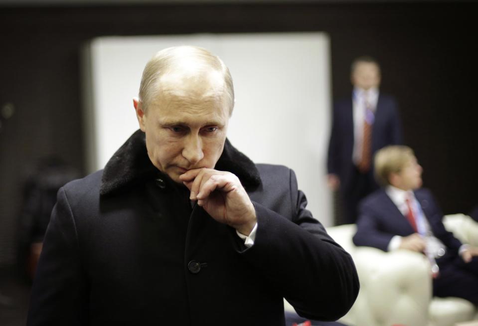 Russian President Vladimir Putin waits in the presidential lounge to be introduced at the opening ceremony of the 2014 Winter Olympics, Friday, Feb. 7, 2014, in Sochi, Russia. (AP Photo/David Goldman, Pool)