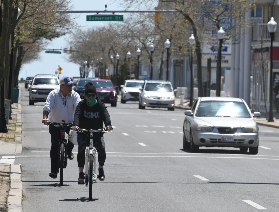 Folks ride their bicycles on Baltimore Avenue  Sunday, May 10, 2020 after the town  opened the beach and Boardwalk that had been closed since mid-March due to  the COVID-19 pandemic.