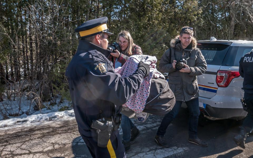 Canadian police officer carries a refugee baby - Credit: David Millward/The Telegraph