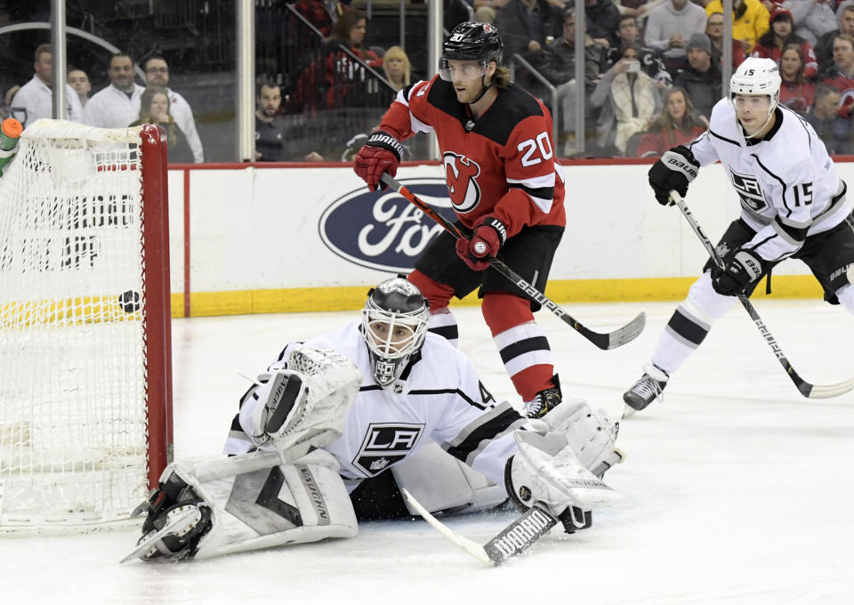 Los Angeles Kings goaltender Calvin Petersen (40), defenseman Ben Hutton (15) and New Jersey Devils center Blake Coleman (20) watch the puck go into the net for a goal by Devils' Nikita Gusev (not shown) during the second period of an NHL hockey game Saturday, Feb. 8, 2020, in Newark, N.J. (AP Photo/Bill Kostroun)