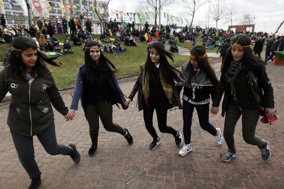 Young girls dance after Turkish authorities permitted the Newroz celebration, in Diyarbakir, Turkey, Tuesday, March 21, 2017. Thousands celebrated the Newroz festival in Istanbul and in Diyarbakir, a mainly Kurdish city in a region where Kurdish militants regularly clash with government forces. Many flags proclaimed “No” in the Turkish and Kurdish languages, referring to President Recep Tayyip Erdogan’s bid to gain more power for his office in an April 16 referendum. (AP Photo/Lefteris Pitarakis)