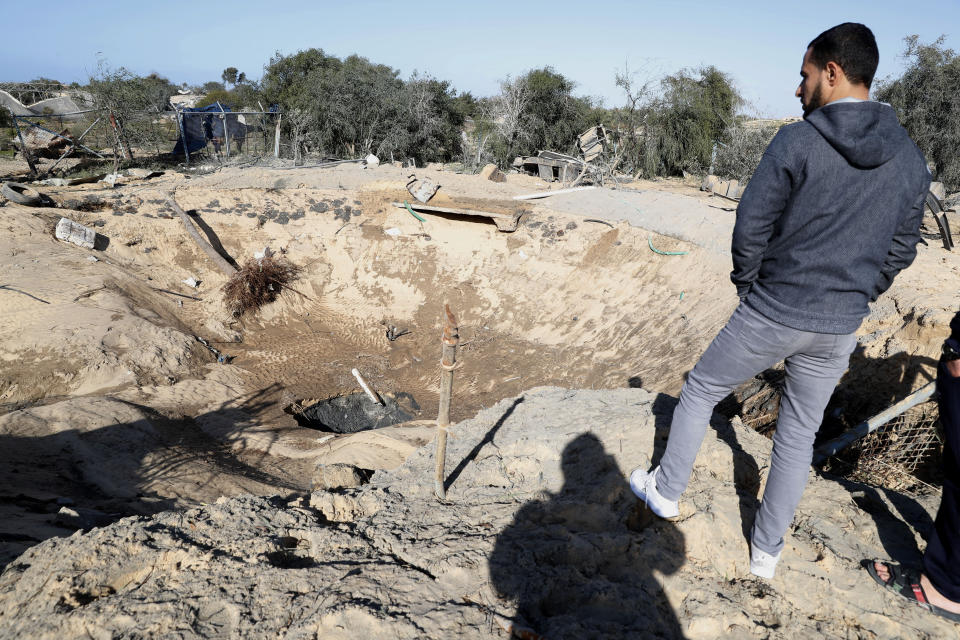 A resident inspects a crater and the rubble of destroyed a water well following overnight Israeli missile strikes, in Rafah, southern Gaza Strip, Friday, Jan. 31, 2020. Israel launched airstrikes on militant targets in the Gaza Strip shortly after Palestinians fired three rockets into Israel, two of which were intercepted, the military said Friday. (AP Photo/Adel Hana)