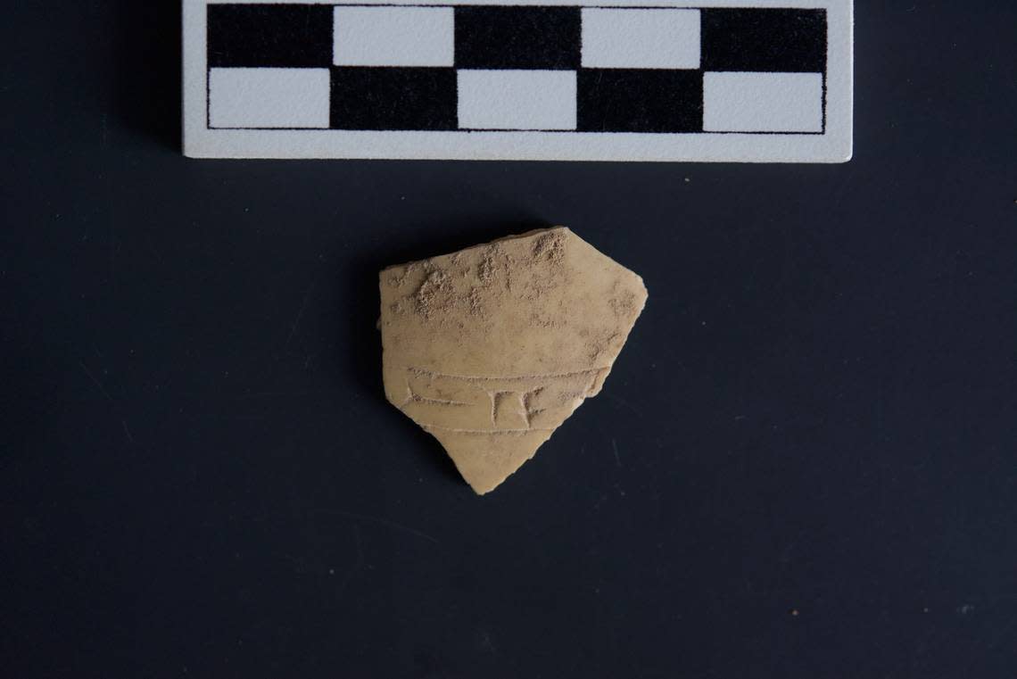 A fragment of ostrich egg shell with cuneiform carvings.