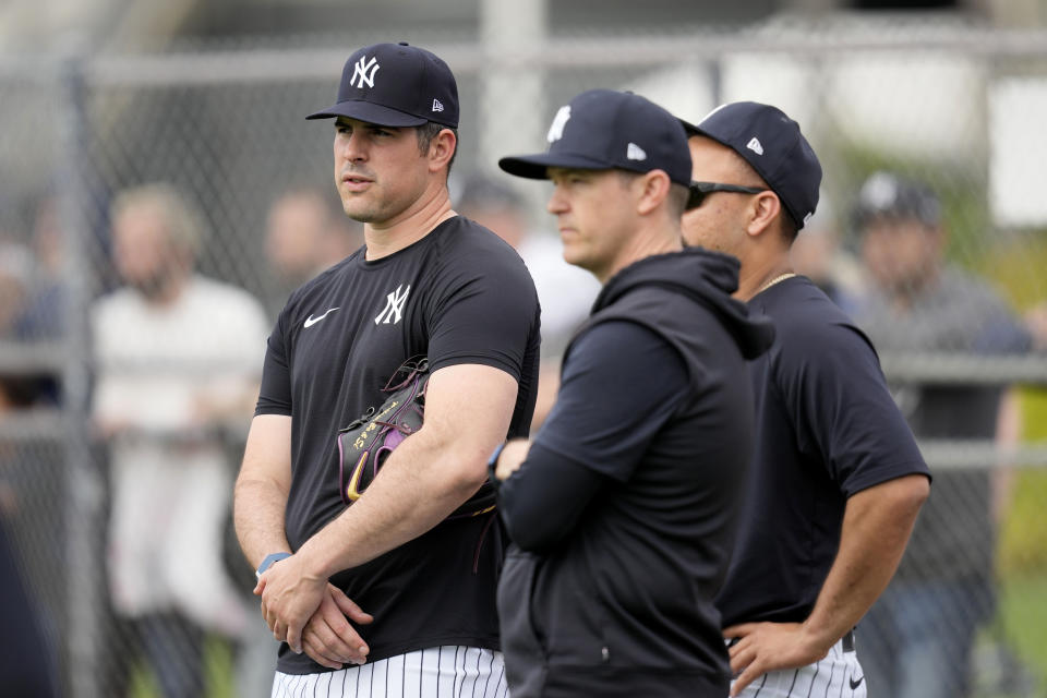 New York Yankees pitcher Carlos Rodon, left, watches a baseball spring training workout Thursday, Feb. 15, 2024, in Tampa, Fla. (AP Photo/Charlie Neibergall)