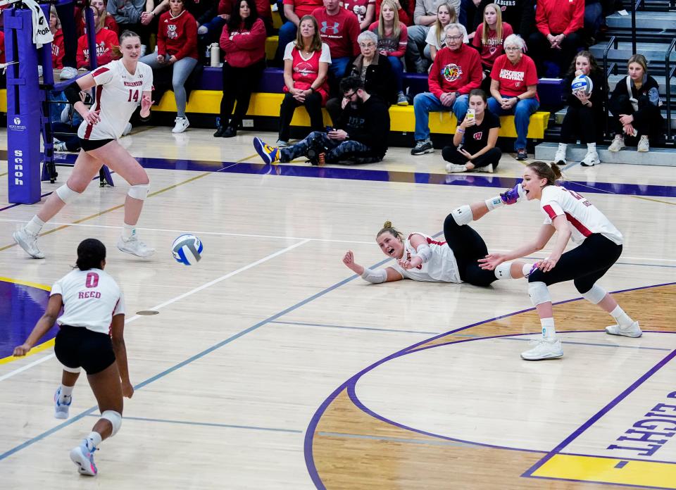 Wisconsin setter MJ Hammill (6) dives for the save as libero Sydney Reed (0) dives to return during the second set of their scrimmage match against Marquette on Friday March 31, 2023 at Oconomowoc High School in Oconomowoc, Wis.