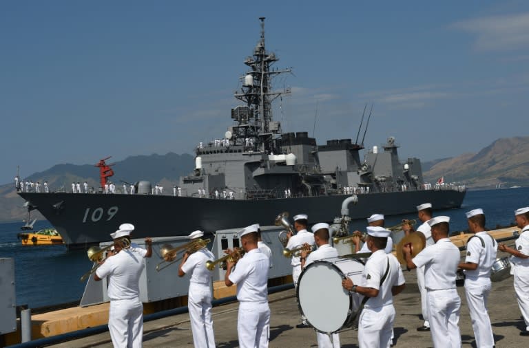 A Philippine navy band plays during a welcoming ceremony for Japanese destroyer JS Ariake, at a port of the former US naval base in Subic bay, north of Manila, on April 3, 2016