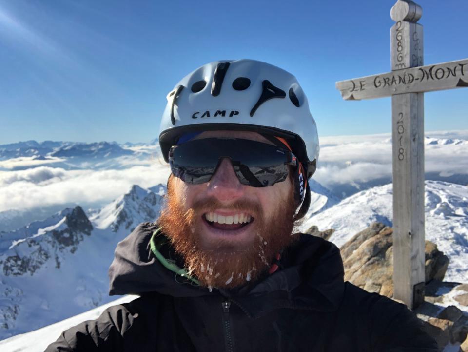 Rockford native Cam Smith, the first North American man to finish in the top three of a World Cup ski mountaineering race, poses at the top of a mountain.