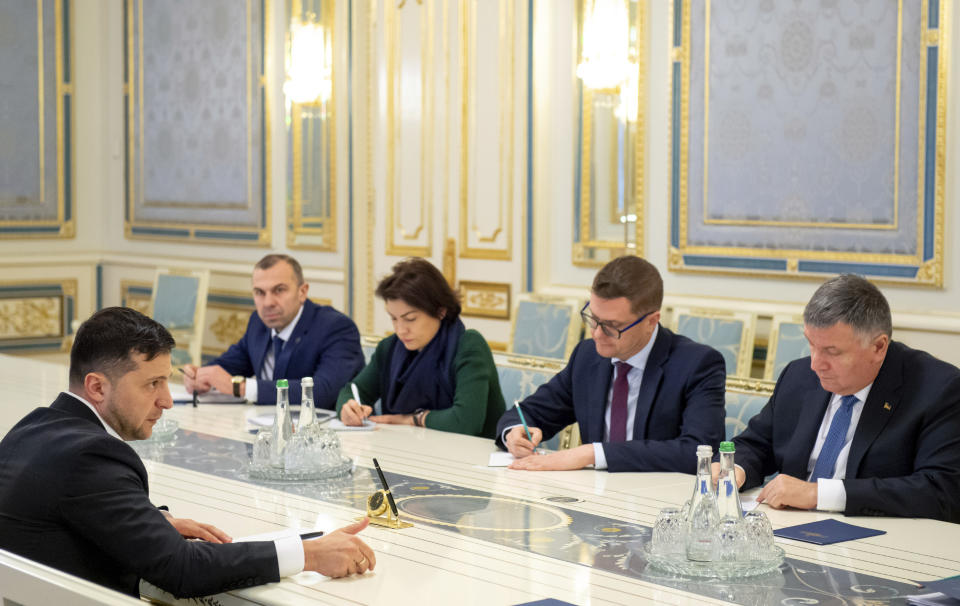 In this photo provided by the Ukrainian Presidential Press Office, Ukrainian President Volodymyr Zelenskiy, left, speaks during a meeting with cabinet members and security officials in Kyiv, Ukraine, Friday, Jan. 17, 2020. Ukraine's prime minister submitted his resignation Friday, days after he was caught on tape saying the country's president knows nothing about the economy. Zelenskiy demanded that the provenance of the tapes be investigated. (Ukrainian Presidential Press Office via AP)