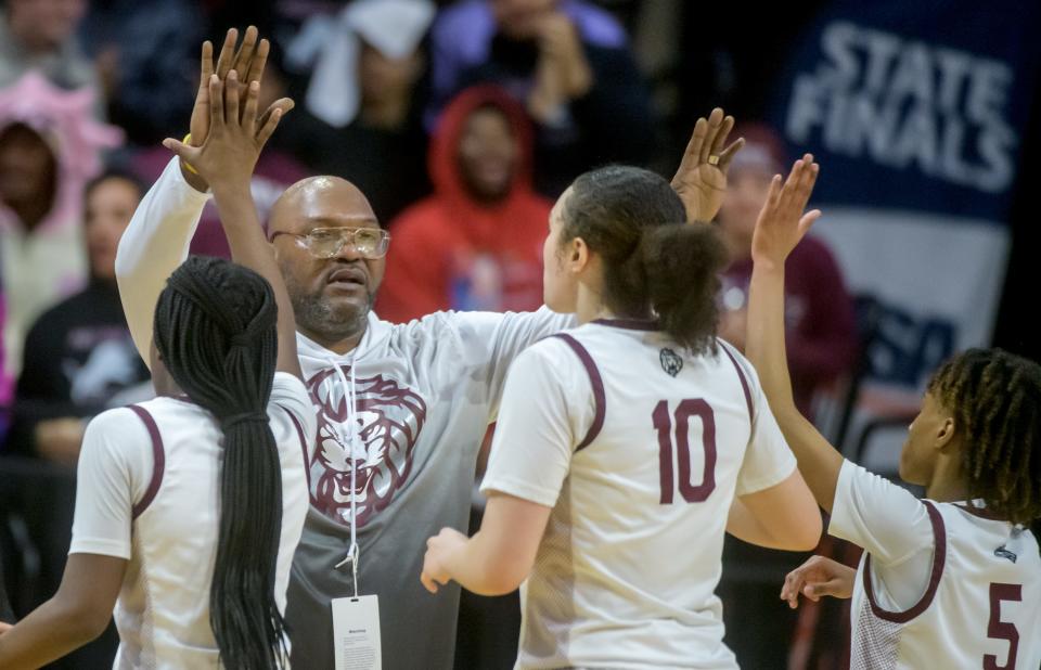 Peoria High head coach Meechie Edwards high-fives his players as they come off the court during a timeout in the first half of the Class 3A state semifinals Friday, March 3, 2023 at CEFCU Arena in Normal. The Lions fell to the Nazareth Academy Roadrunners 48-35.