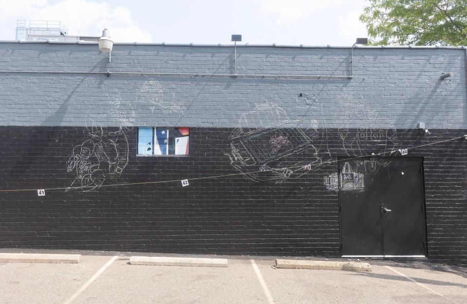 A sketching for a new mural appears on the side of the former Buzzbin building where the Greetings from Canton postcard-style mural had been.