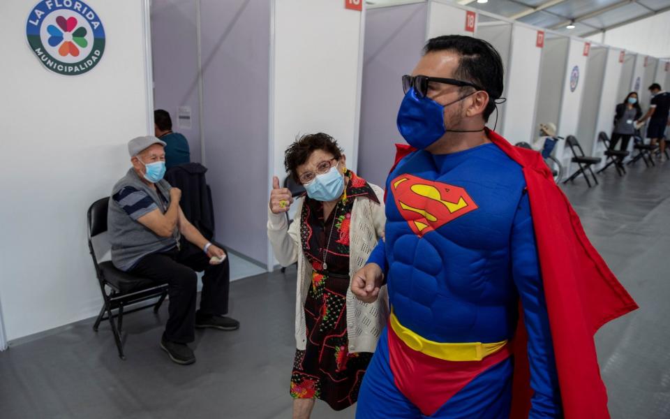 A man dressed as Superman accompanies his mother to get vaccinated in Santiago - Alberto Valdes/EPA-EFE/Shutterstock 