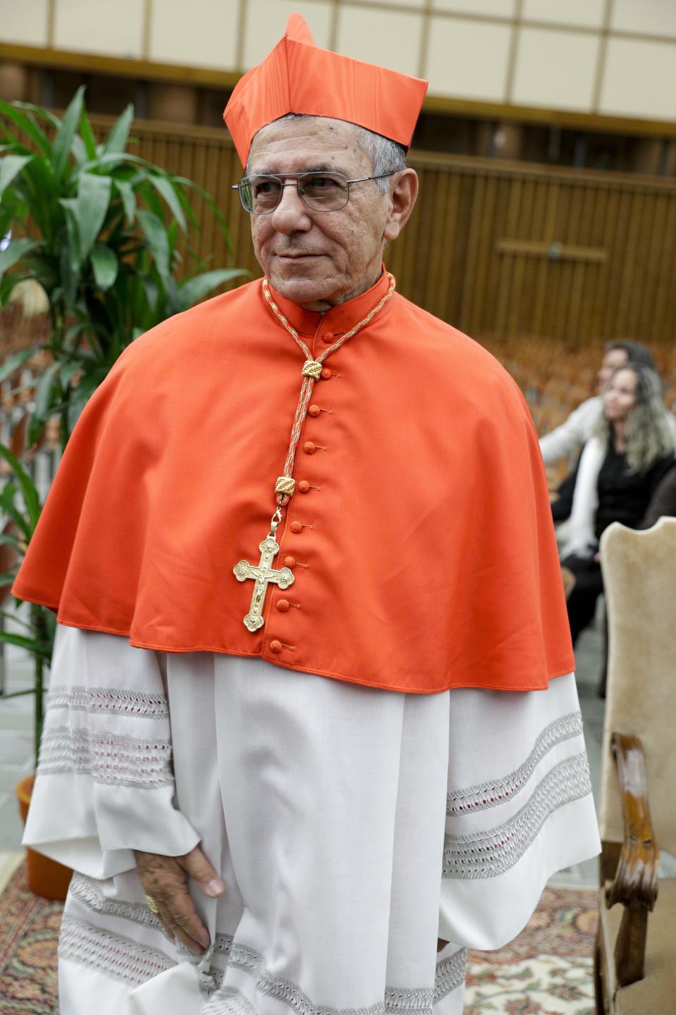 Cardinal Juan de la Caridad Garcia Rodriguez poses for photographers prior to meeting relatives and friends after he was elevated to cardinal by Pope Francis, at the Vatican, Saturday, Oct. 5, 2019. Pope Francis has chosen 13 men he admires and whose sympathies align with his to become the Catholic Church's newest cardinals. (AP Photo/Andrew Medichini)