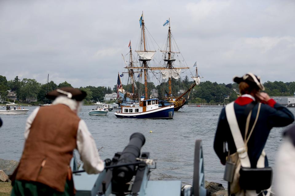 Militia members set off a cannon greeting tall ships during The Parade of Sail in Portsmouth Thursday, Aug. 11, 2022.