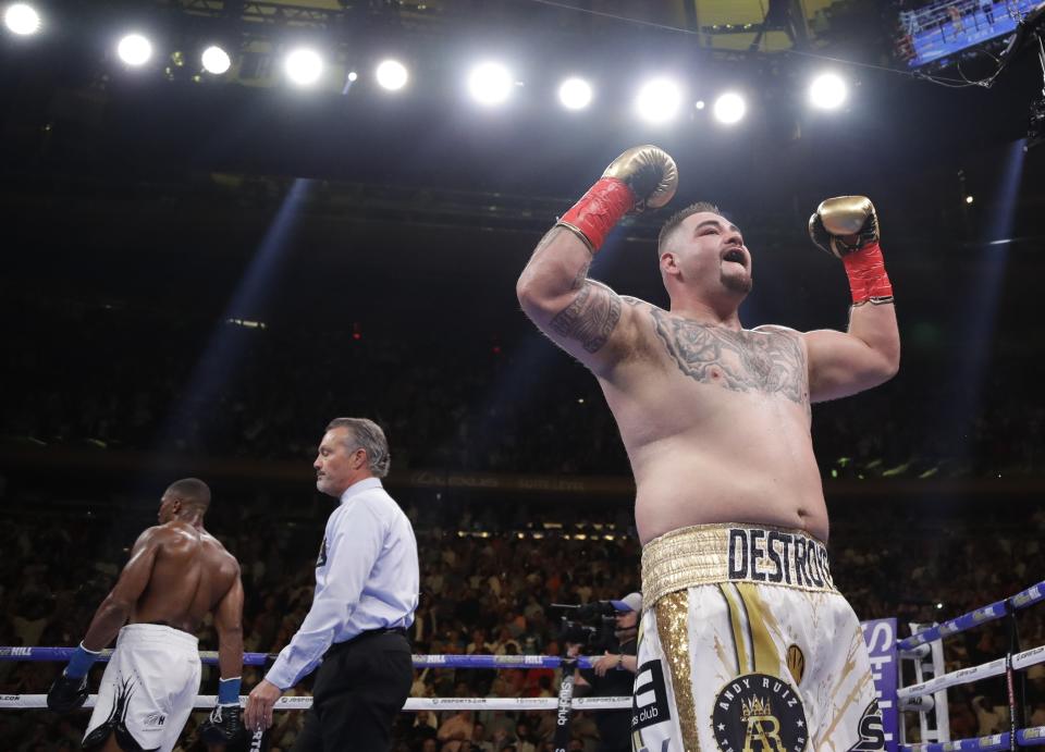 Andy Ruiz, right, celebrates after the third round of a heavyweight championship boxing match against Anthony Joshua, left, Saturday, June 1, 2019, in New York. Ruiz won in the seventh round. (AP Photo/Frank Franklin II)