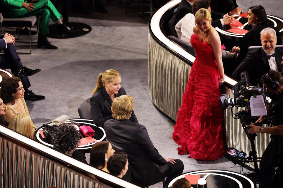 Amy Schumer sits next to Jesse Plemons on-camera as Kirsten Dunst looks on, laughing. (Neilson Barnard / Getty Images)