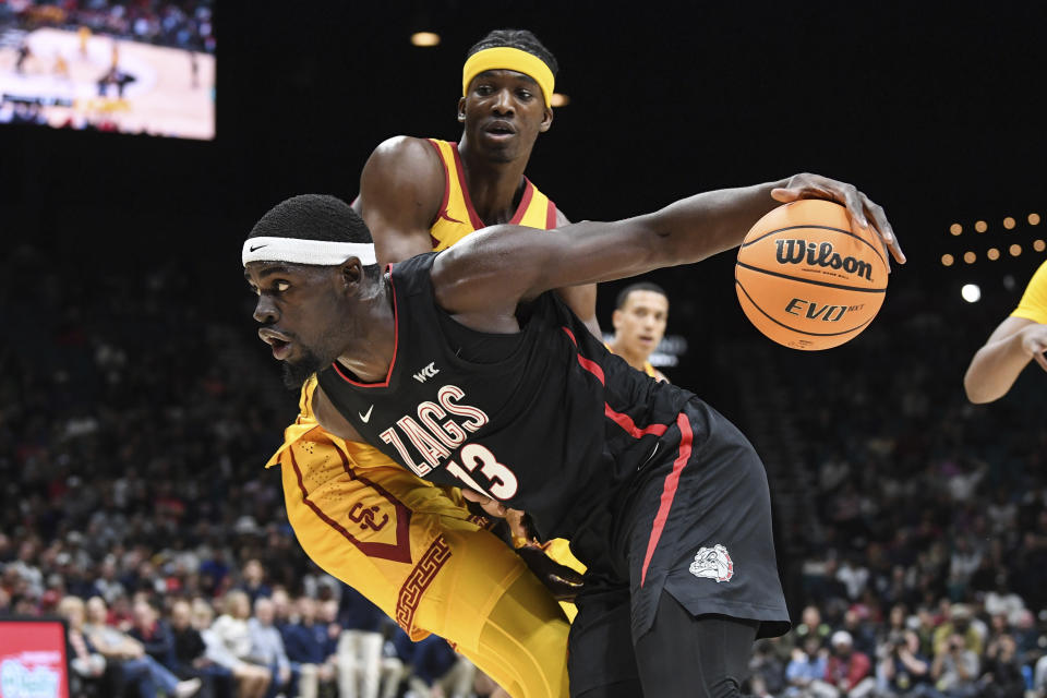 Gonzaga forward Graham Ike (13) drives past Southern California forward Vincent Iwuchukwu (3) during the first half of an NCAA college basketball game Saturday, Dec. 2, 2023, in Las Vegas. (AP Photo/Sam Morris)