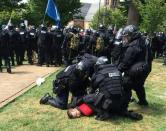 In this twitter hand-out photo courtesy the Virginia State Police, arrests are made following declaration of unlawful assembly at Emancipation Park in Charlottesville, Virginia on August 12, 2017