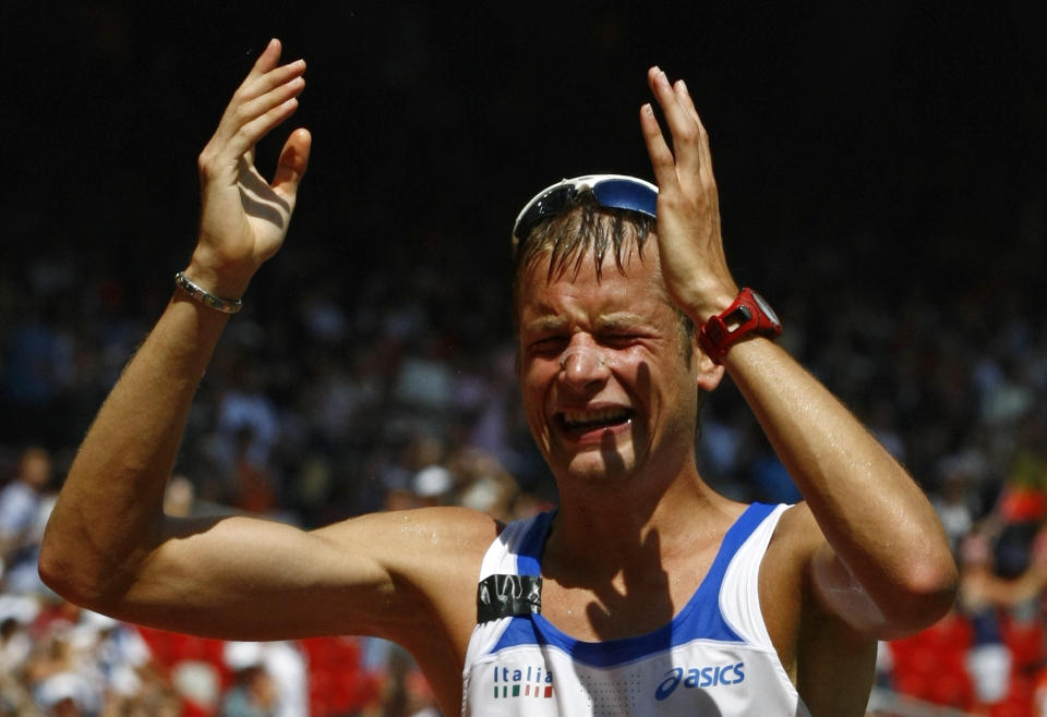 Alex Schwazer of Italy reacts after winning the men's 50km walk in the athletics competition of the Beijing 2008 Olympic Games in the National Stadium August 22, 2008.     REUTERS/Ruben Sprich (CHINA)