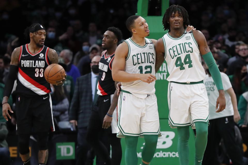 Boston Celtics' Grant Williams (12) talks with Robert Williams III (44) after a missed scoring opportunity during the second half of an NBA basketball game against the Portland Trail Blazers, Friday, Jan. 21, 2022, in Boston. (AP Photo/Michael Dwyer)