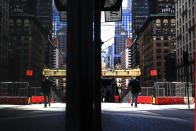 A person wearing a protective face mask walks in New York, Monday, April 6, 2020, during the current coronavirus outbreak. (AP Photo/Matt Rourke)