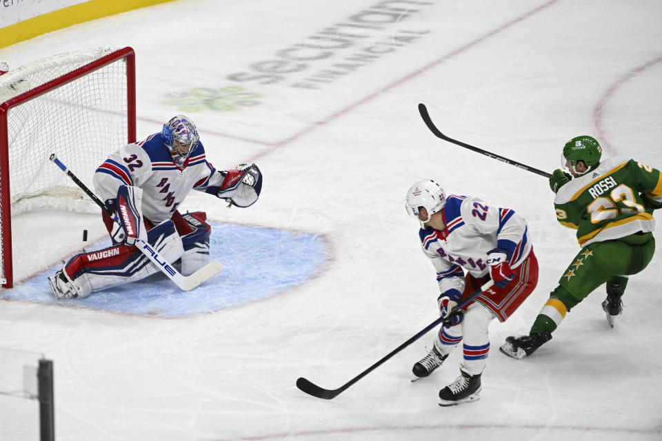 Minnesota Wild center Marco Rossi, right, shoots past New York Rangers goalie Jonathan Quick (32) and center Jonny Brodzinski (22) to score during the third period of an NHL hockey game Saturday, Nov. 4, 2023, in St. Paul, Minn. (AP Photo/Craig Lassig)