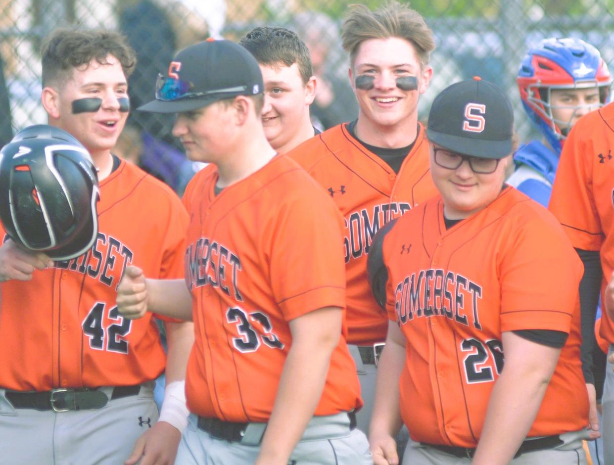 Somerset's Lane Lambert, back row, center, is all smiles after launching a grand slam in the first inning of an LHAC baseball contest against Richland, Wednesday, in Somerset.