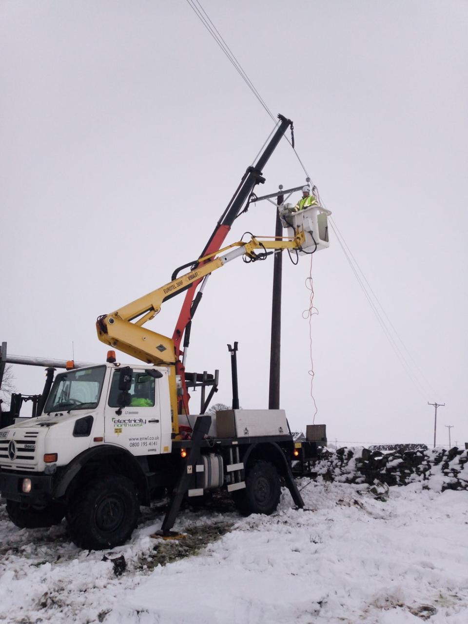 Workers repair a broken power line following Storm Arwen (ENA/PA) (PA Media)