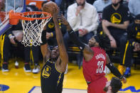 Golden State Warriors center Kevon Looney (5) dunks against Portland Trail Blazers forward Robert Covington (33) during the first half of an NBA basketball game in San Francisco, Wednesday, Dec. 8, 2021. (AP Photo/Jeff Chiu)
