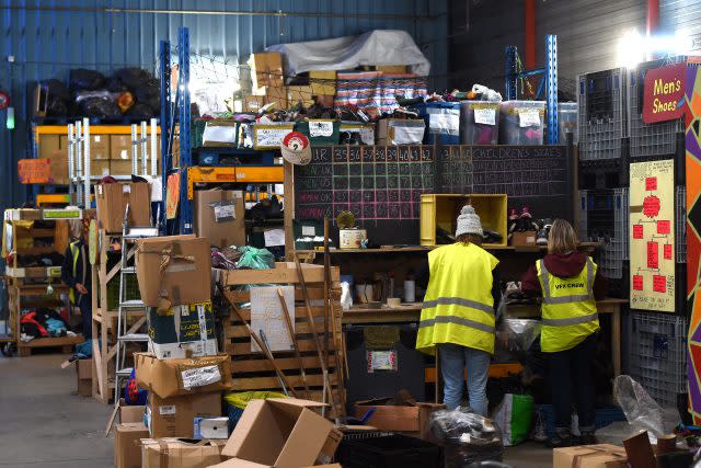 Volunteers sort donations at a warehouse in Calais