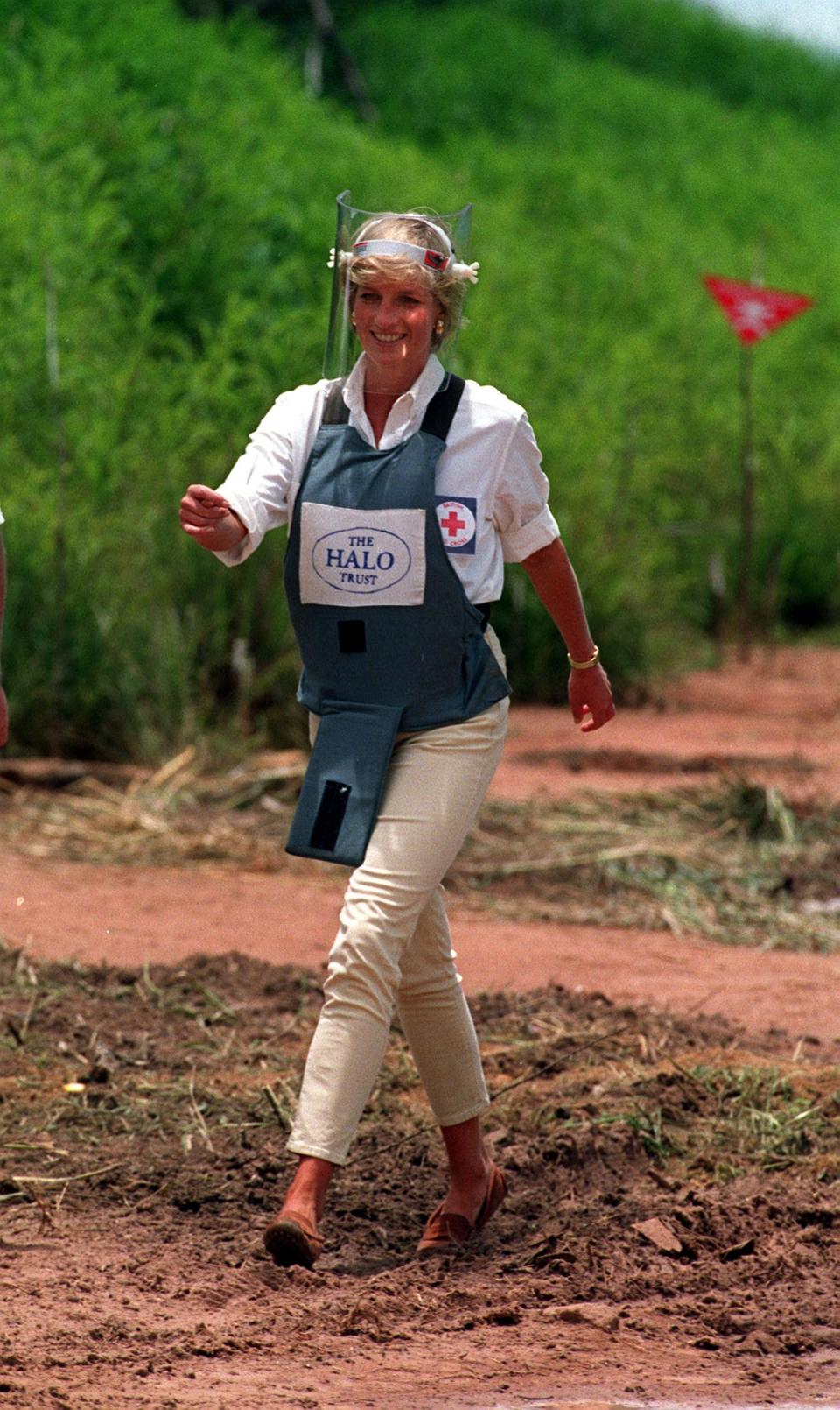 Diana walks through a minefield in Angola to see the work of the British Red Cross (John Stillwell/PA) (PA Archive)