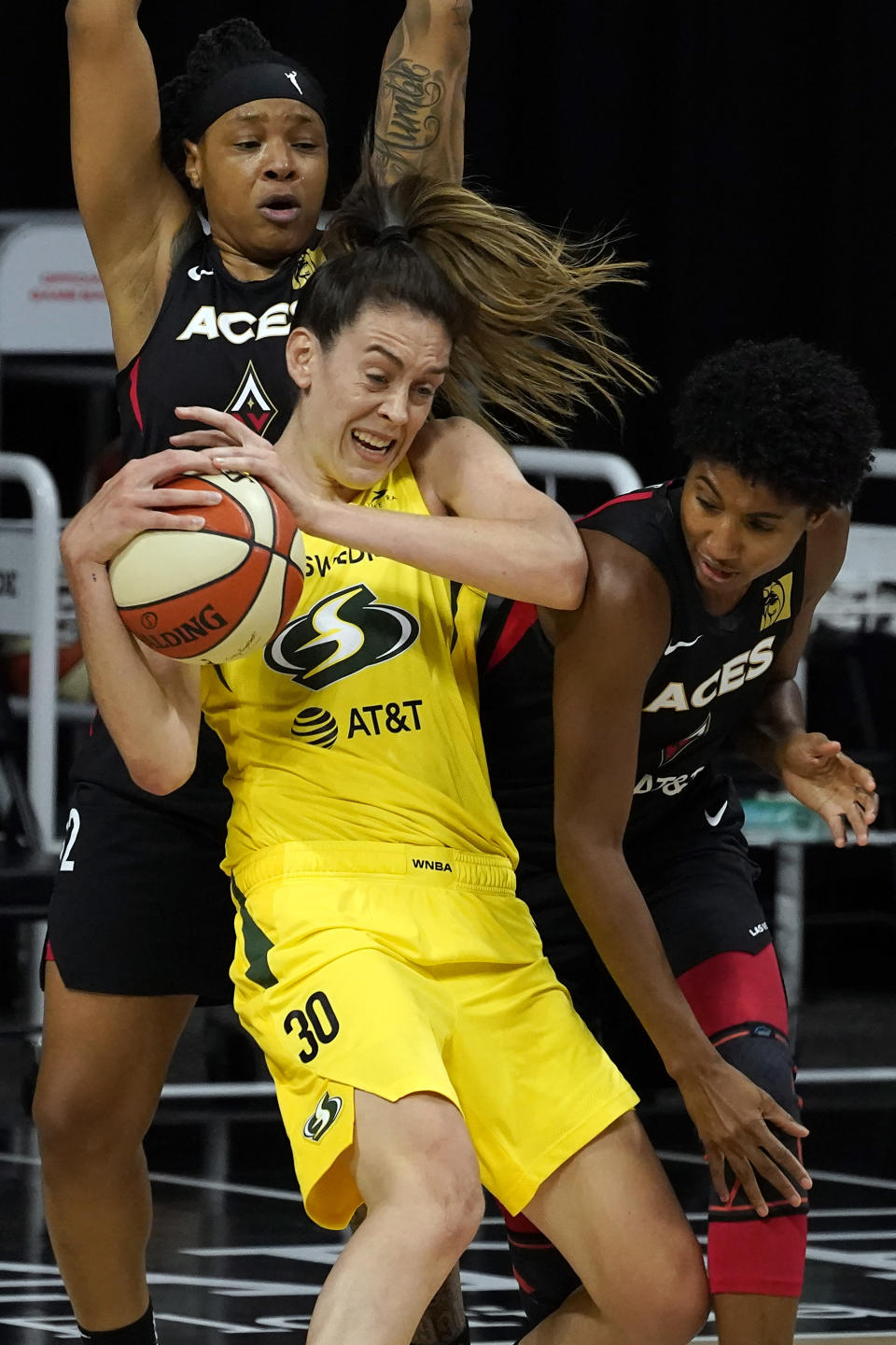 Seattle Storm forward Breanna Stewart (30) battles with Las Vegas Aces forward Angel McCoughtry (35) and forward Emma Cannon (32) for the ball during the first half of Game 1 of basketball's WNBA Finals Friday, Oct. 2, 2020, in Bradenton, Fla. (AP Photo/Chris O'Meara)