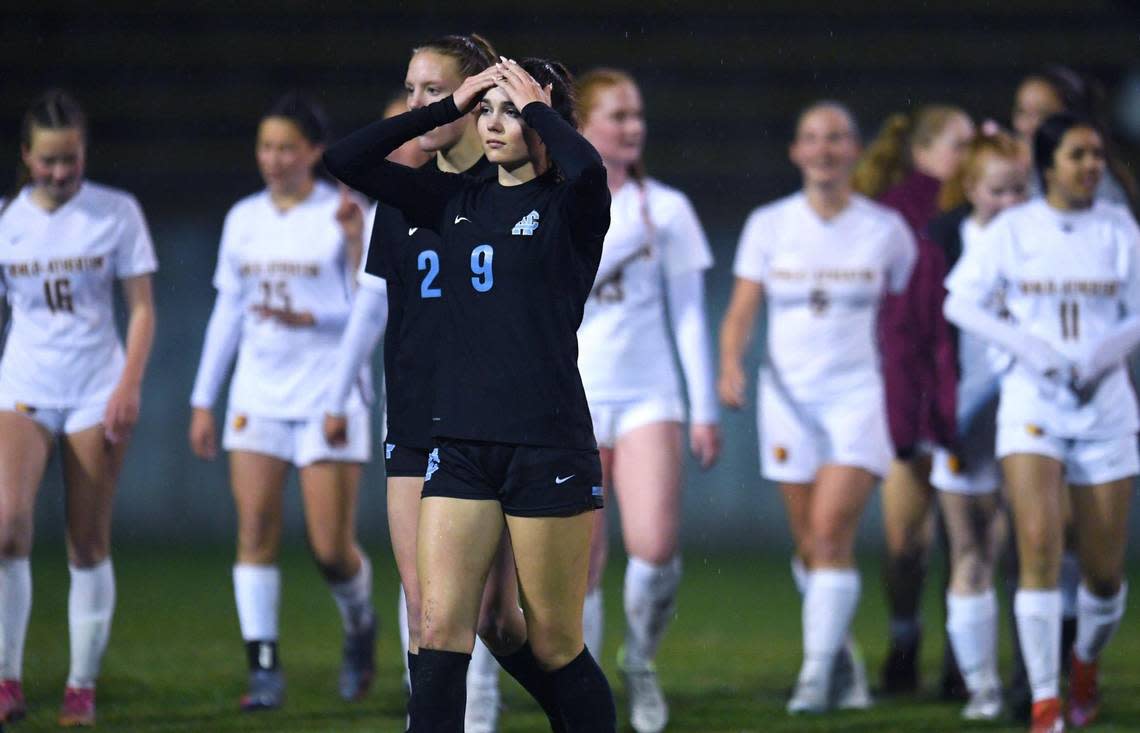 Clovis North’s Hannah Peters, center, walks off the field as Menlo-Atherton celebrates its 1-0 win, background, in the CIF Northern California Regional girls playoff game Tuesday, Feb. 2, 2023 in Clovis.