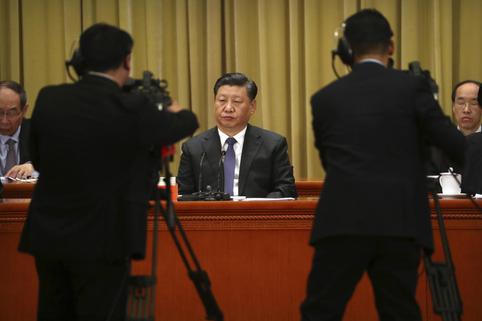 Chinese President Xi Jinping, center, listens to a speech during an event to commemorate the 40th anniversary of the Message to Compatriots in Taiwan at the Great Hall of the People in Beijing, Wednesday, Jan. 2, 2019. Xi urged both sides to reach an early consensus on the unification of China and Taiwan and not leave the issue for future generations. (AP Photo/Mark Schiefelbein, Pool)