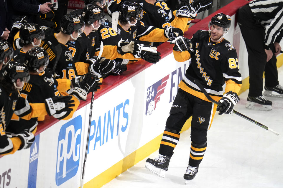 Pittsburgh Penguins' Sidney Crosby (87) returns to the bench after scoring during the first period of an NHL hockey game against the Los Angeles Kings in Pittsburgh, Sunday, Feb. 18, 2024. (AP Photo/Gene J. Puskar)