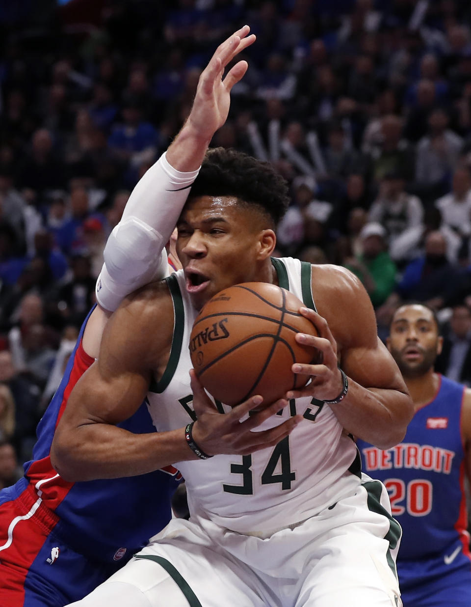 Milwaukee Bucks forward Giannis Antetokounmpo (34) is defended by Detroit Pistons forward Blake Griffin during the first half of Game 3 of a first-round NBA basketball playoff series, Saturday, April 20, 2019, in Detroit. (AP Photo/Carlos Osorio)