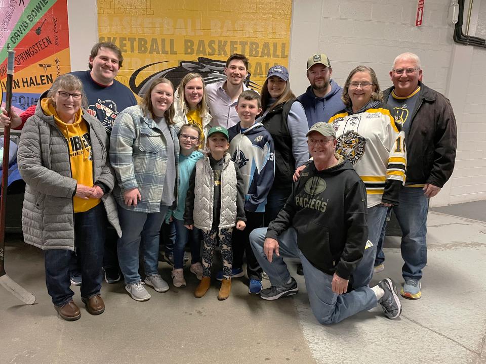 Tracy and Butch Ward and their extended family pose with Admirals left wing John Leonard after a game in March.